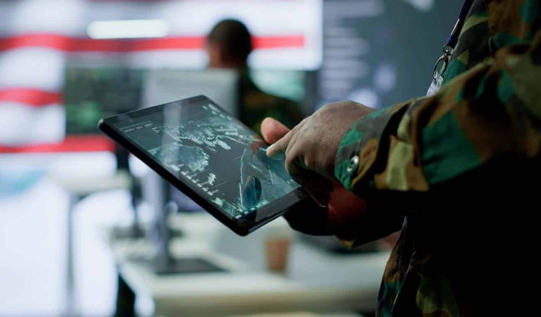 US soldiers in a cyber control center engaging in cybersecurity operations, handles classified information and ensures security of state secrets and government data. Surveillance footage. Camera A.